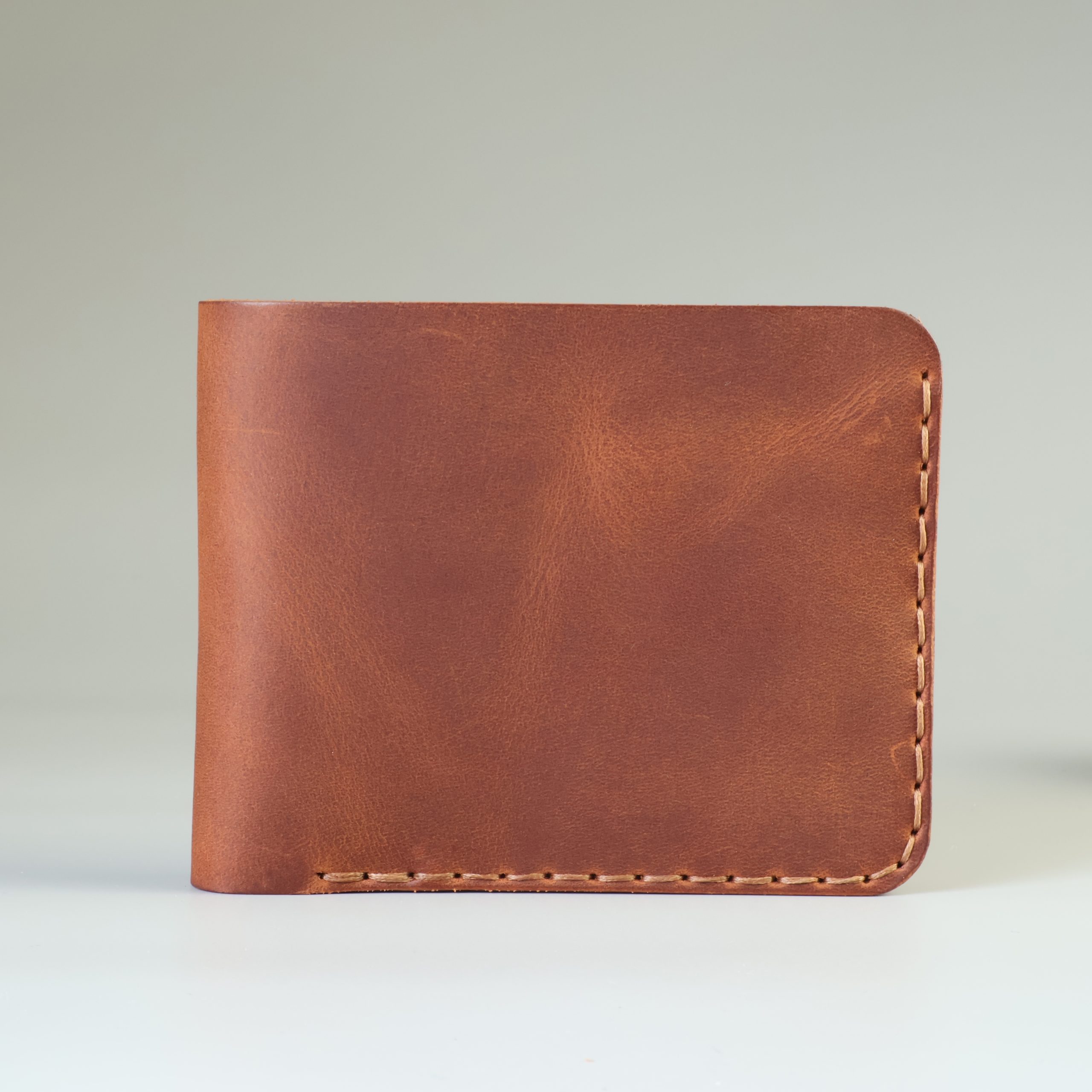 Slim leather bifold with hand-stitching open slots