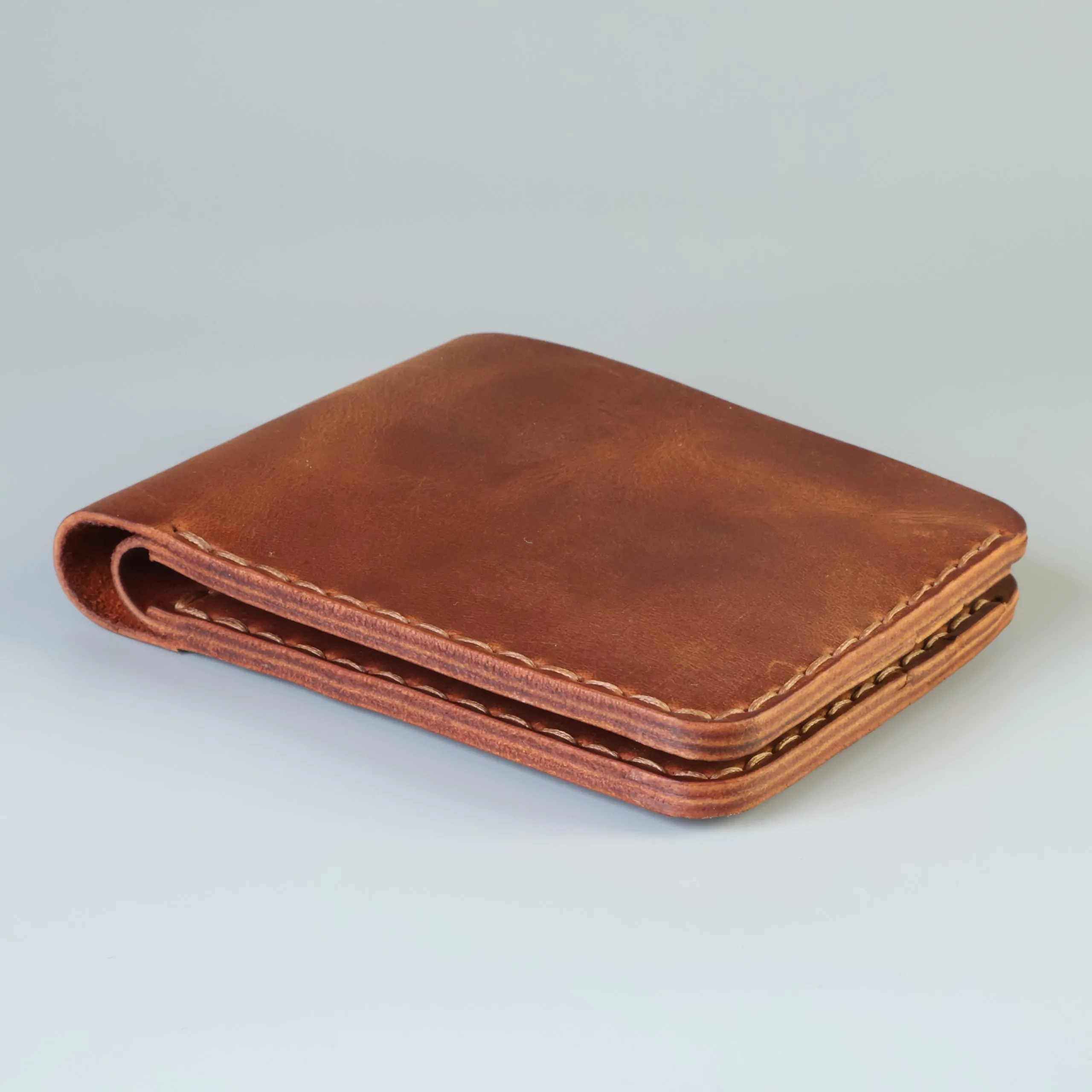 Slim leather bifold with hand-stitching open slots