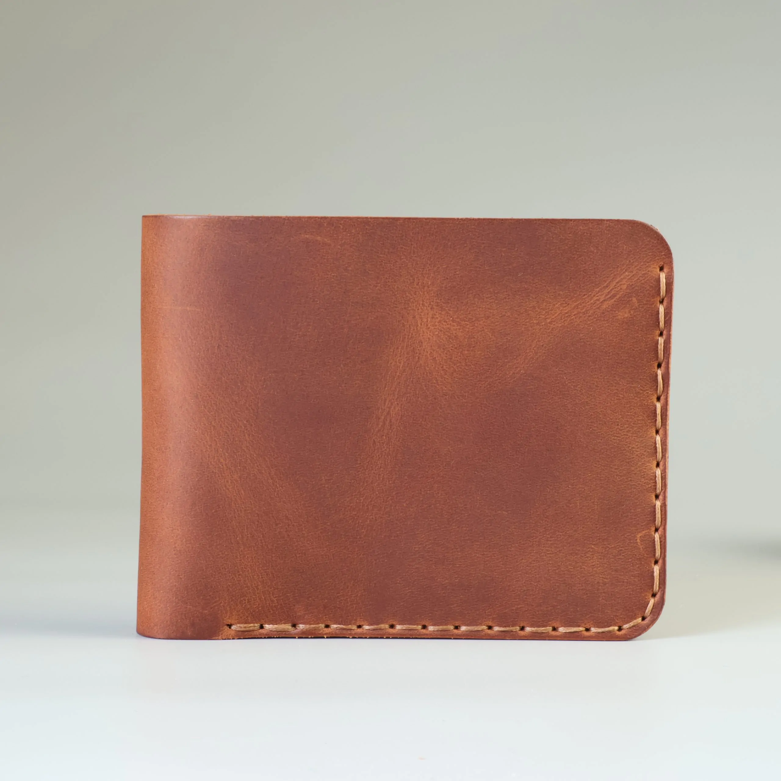Slim leather bifold with hand-stitching open slots