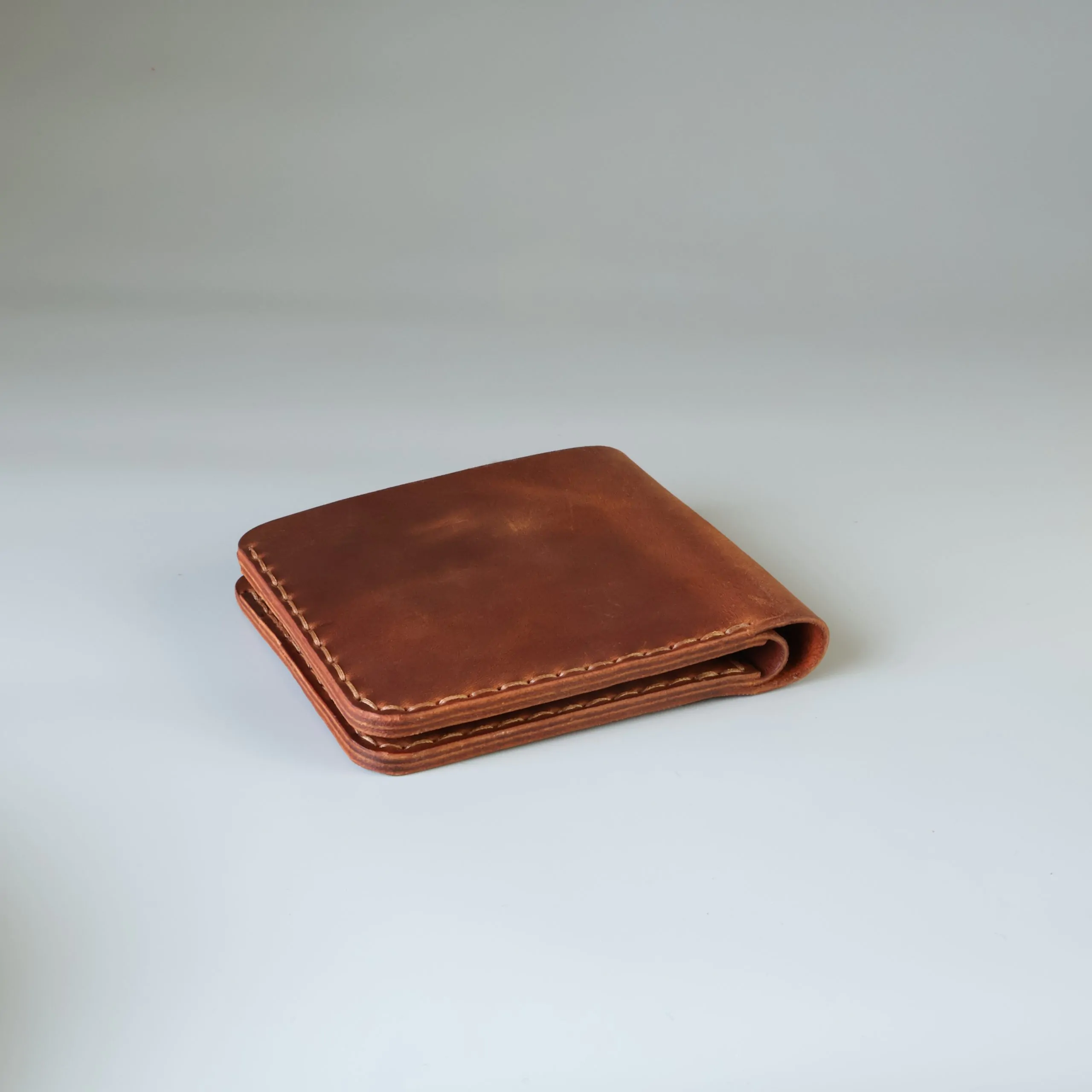 Slim leather bifold with hand-stitching open slots